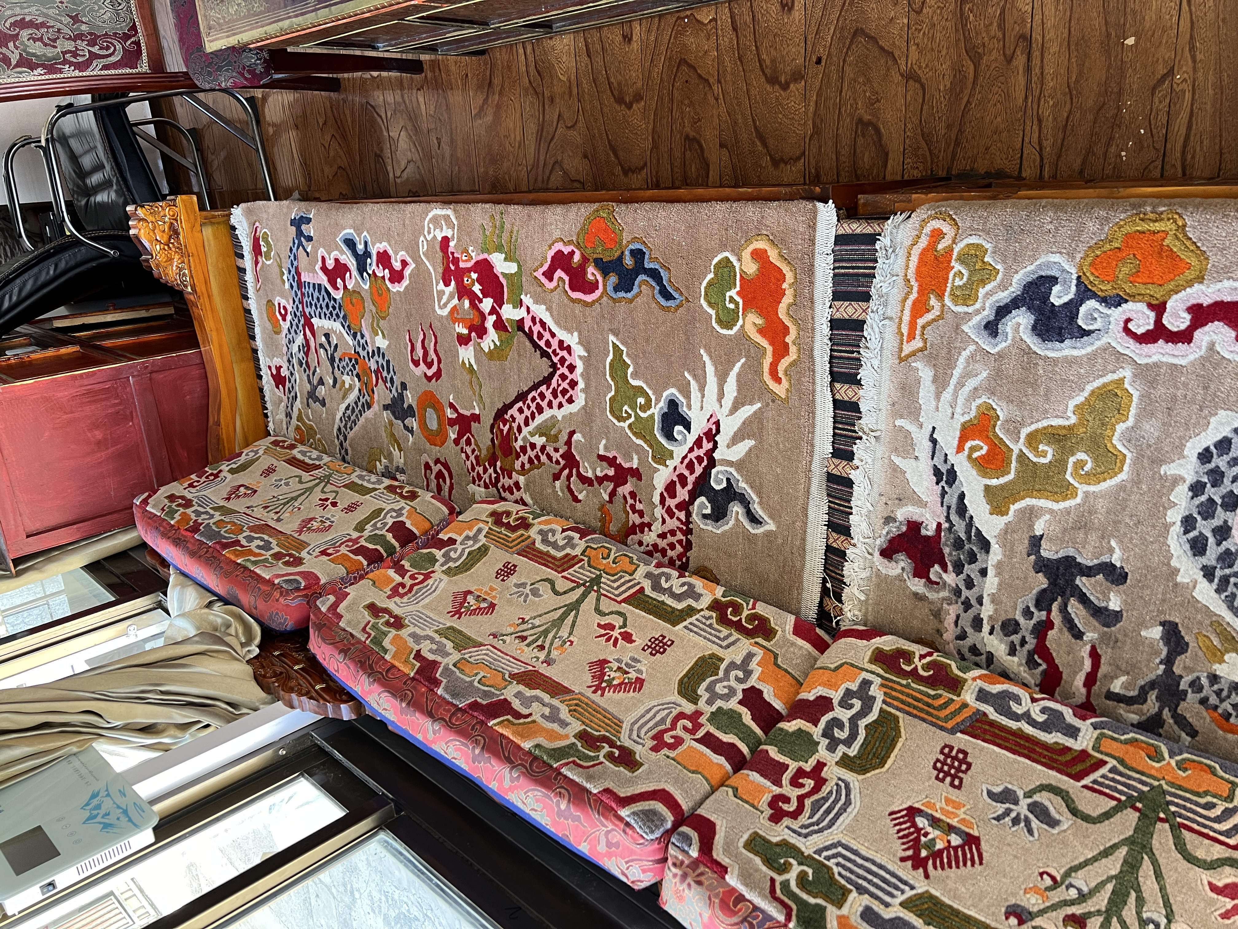 Artisan weaving a Tibetan carpet on a traditional vertical loom